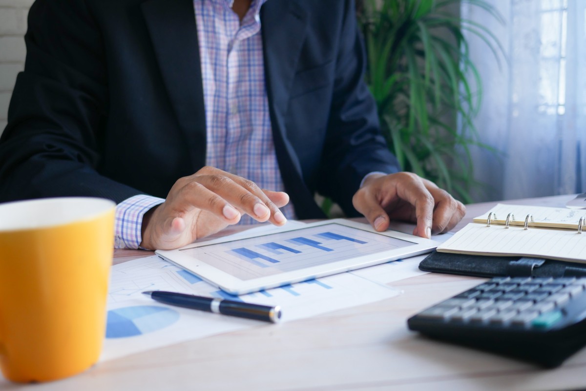 man using tablet for financial transaction